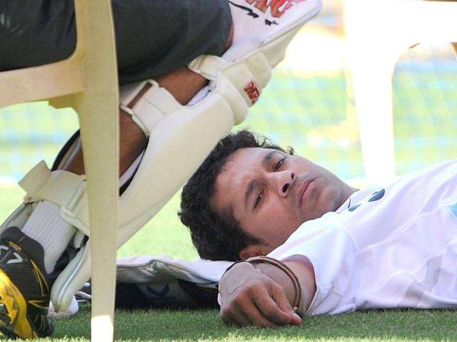 Sachin Tendulkar lies on the ground during a practice session at the Wankhede stadium in Mumbai.
