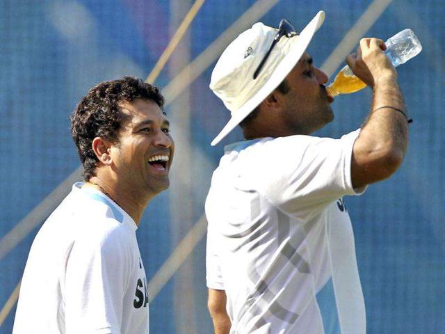 Sachin Tendulkar, left, looks at teammate Virender Sehwag who sips a drink during a training session ahead of their third Test cricket match against West Indies in Mumbai.