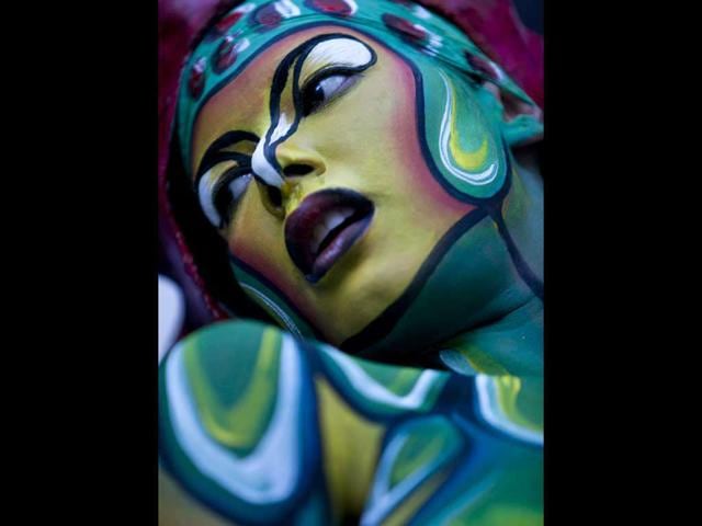 A woman with her body painted poses at the Teresa Carreno's theater during the VI World Meeting of Body Art in Caracas, Venezuela. Activities such as body painting, tattooing, performances, workshops and conferences are part of the event.
