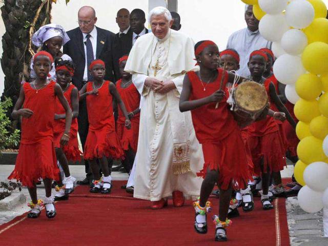 Youth dance around Pope Benedict XVI, during his visit at the "Peace and Joy" foyer of the Missionaries of Charity at St Rita Parish of Cotonou in the second of his three-day trip his trip to the Africa's western coast country of Benin.