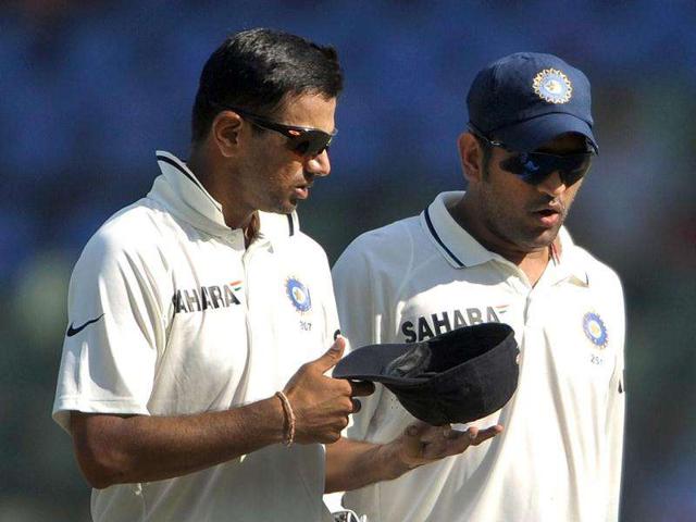 Rahul Dravid (L) speaks with captain Mahendra Singh Dhoni during the first day of the third cricket test match between India and West Indies at the Wankhede stadium in Mumbai.