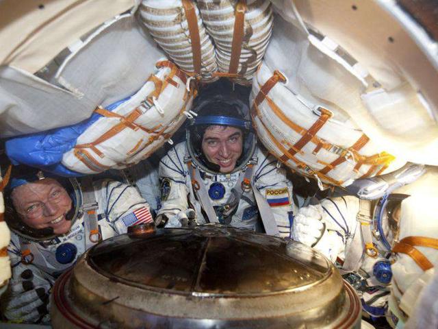 ISS members from left, US astronaut Michael Fossum, Russian cosmonaut Sergei Volkov and Japanese astronaut Satoshi Furukawa smile from inside the Soyuz capsule minutes after they landed near the town of Arkalyk, northern Kazakhstan. Three astronauts, including Japan's Satoshi Furukawa, American Mike Fossum and Russia's Sergei Volkov, landed today safely in the Kazakh steppe aboard a Russian Soyuz capsule after a stay of over five months aboard the International Space Station, Russian mission control said. AP Photo/Sergei Remizov