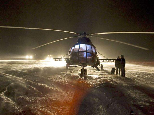 A helicopter crew gets ready at Arkalyk airfield in preparation for the recovery mission of the Soyuz TMA-02M spacecraft with ISS crew of US astronaut Michael Fossum, Russian cosmonaut Sergey Volkov and Japanese astronaut Satoshi Furukawa, near the town of Arkalyk in northern Kazakhstan. Reuters/Shamil Zhumatov