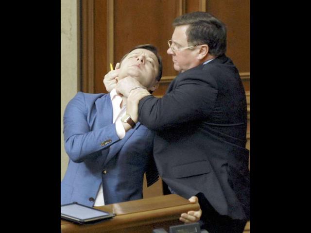 Vice speaker of the Ukrainian Vekhovnaya Rada, Adam Martynyuk (R), scuffles with deputy Oleg Lyashko during a session in the chamber of the Ukrainian parliament in Kiev on May 18, 2011.