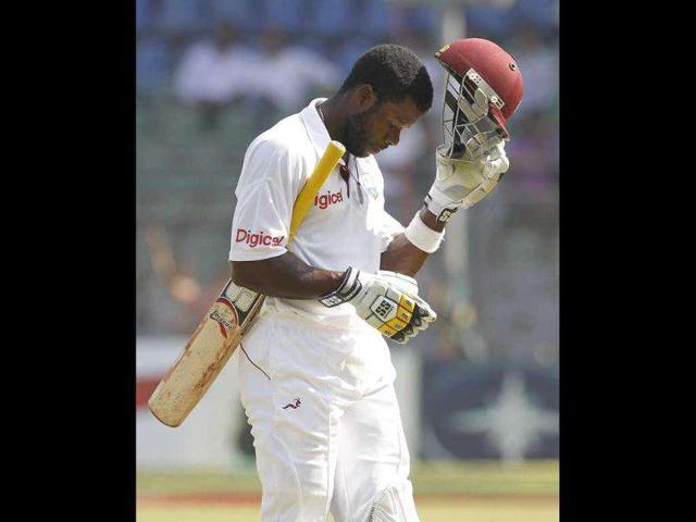 West Indies' Kirk Edwards walks off the field after he was dismissed by India's Ishant Sharma during the second day of their third test cricket match in Mumbai.