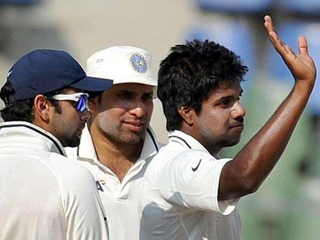 Indian-bowler-Varun-Aaron-R-celebrates-with-team-mates-VVS-Laxman-C-and-Virat-Kohli-after-taking-wicket-of-West-Indies-batsman-Darren-Bravo-during-the-second-day-of-the-third-test-cricket-match-between-India-and-West-Indies-at-the-Wankhede-stadium-in-Mumbai