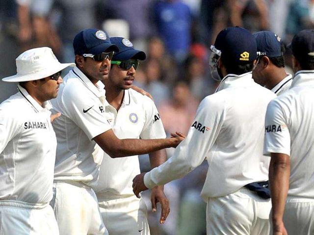 Ravichandran Ashwin (2nd L) celebrates with teammates Varun Aaron (C), Virender Sehwag (L) and others after taking five wickets at the end of West Indies' first innings during the third day's play of the third and final Test cricket match at the Wankhede stadium in Mumbai.