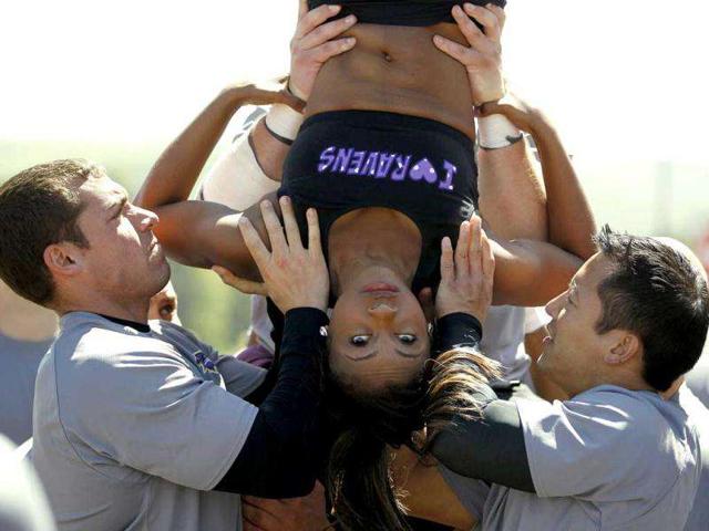 A Baltimore Ravens cheerleader falls during stunt at a training camp at Deep Creek, Maryland.