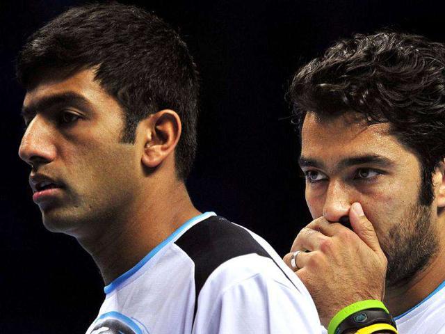 Rohan-Bopanna-of-India-L-and-his-partner-Aisam-ul-Haq-Qureshi-of-Pakistan-R-talk-between-points-against-Marcin-Matkowski-of-Poland-and-his-partner-Mariusz-Fyrstenberg-of-Poland-during-their-group-B-doubles-match-in-the-round-robin-stage-on-day-five-of-the-ATP-World-Tour-Finals-tennis-tournament-in-London-AFP-Photo-Glyn-Kirk Rohan-Bopanna-of-India-L-and-his-partner-Aisam-ul-Haq-Qureshi-of-Pakistan-R-talk-between-points-against-Marcin-Matkowski-of-Poland-and-his-partner-Mariusz-Fyrstenberg-of-Poland-during-their-group-B-doubles-match-in-the-round-robin-stage-on-day-five-of-the-ATP-World-Tour-Finals-tennis-tournament-in-London-AFP-Photo-Glyn-Kirk