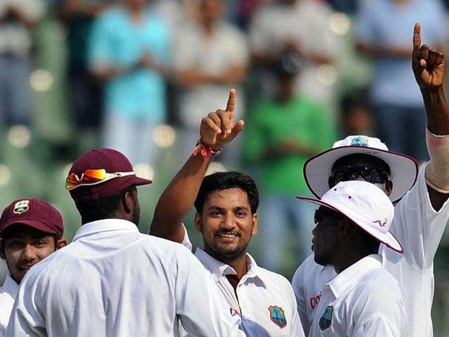 West Indies bowler Ravi Rampaul (C) celebrates with teammates after taking the wicket of Sachin Tendulkar during fourth day's play of the third Test cricket match between India and West Indies at The Wankhede Stadium.
