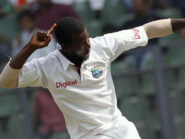 West Indies captain Darren Sammy celebrates after dismissing Mahendra Singh Dhoni during the fourth day of their third and final Test cricket match in Mumbai.