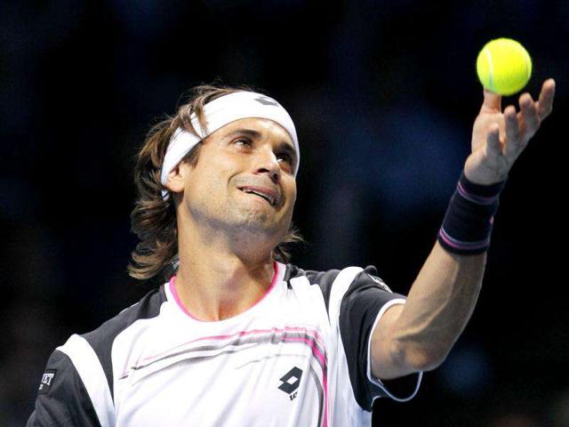 Spain's David Ferrer serves to Tomas Berdych during a round robin single tennis match at the ATP World Tour Finals at O2 Arena in London.
