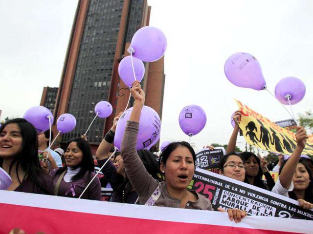 Demonstrators holding balloons participate in a demonstration during the annual International Day for the Elimination of Violence against Women march in Lima. (REUTERS/Pilar Olivares)