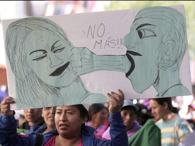 A woman holds a sign that reads," No more", during a rally against abuse and domestic violence in La Paz. Friday marks the International Day for the Elimination of Violence against Women (REUTERS/Gaston Brito)