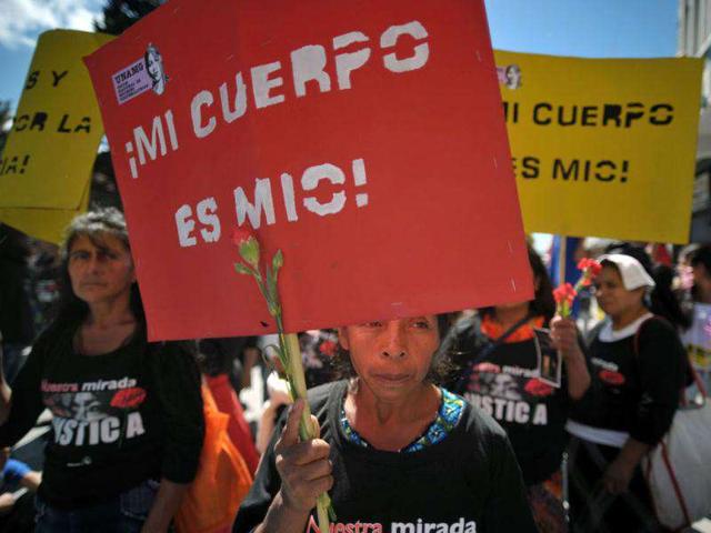 A woman holds a sign reading "My body is mine!" during a demonstration during the commemoration of the International Day for the Elimination of Violence Against Women, in Guatemala City. 651 women have died due to violent events in Guatemala this year. (AFP PHOTO/Johan ORDONEZ)