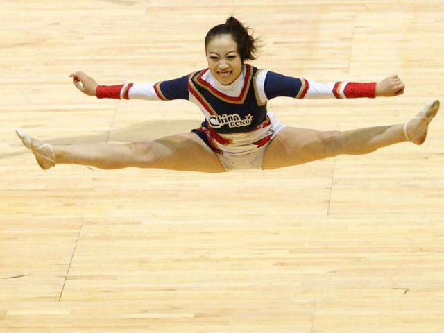 A member of the Chinese team performs during the cheer dance competition at the the Cheerleading World Championships in Hong Kong. The 6th Cheerleading World Championships is a biennial event featuring some 70 teams from over 20 countries. AFP PHOTO / Dale de la Rey