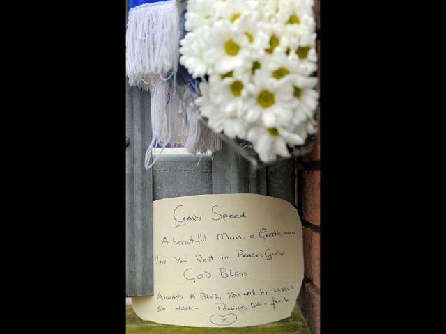 A written tribute to Wales football manager Gary Speed is pictured on the gates to Everton's Goodison Park stadium in north-west England. AFP Photo/Andrew Yates