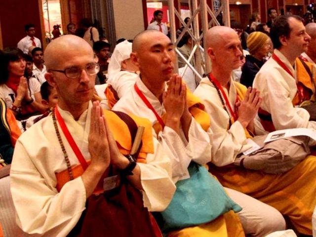 Buddhist monks pray at the opening of the Global Buddhist Congregation to commemorate the 2,600th year of Sambodhiprapti, or the enlightenment of Buddha, in New Delhi.