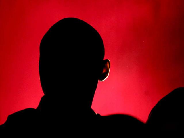 A Buddhist monk listening to a speaker is silhouetted at the opening of the Global Buddhist Congregation to commemorate the 2,600th year of Sambodhiprapti, or the enlightenment of Buddha, in New Delhi.(AP Photo/Manish Swarup)