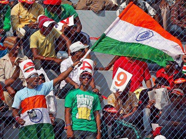 Supporters wave a Tri-colour during the 1st ODI cricket match against West Indies at Barabati Stadium in Cuttack.