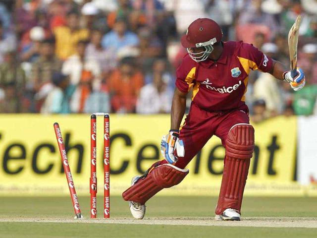 West Indies' Marlon Samuels is bowled by Varun Aaron during their first one-day international cricket match in Cuttack.
