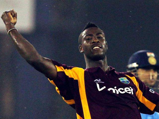 West Indies' Andre Russell celebrate the dismissal of Suresh Raina during the first ODI cricket match in Cuttack.