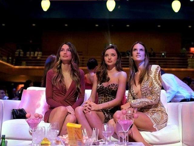 The three angels pose at the party. (AFP)