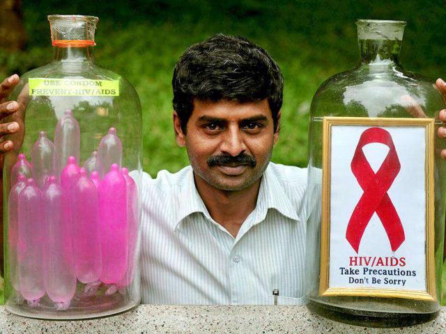 Glass artist Basavarju S Gowda displays his creation as part of an AIDS awareness campaign in Bangalore.