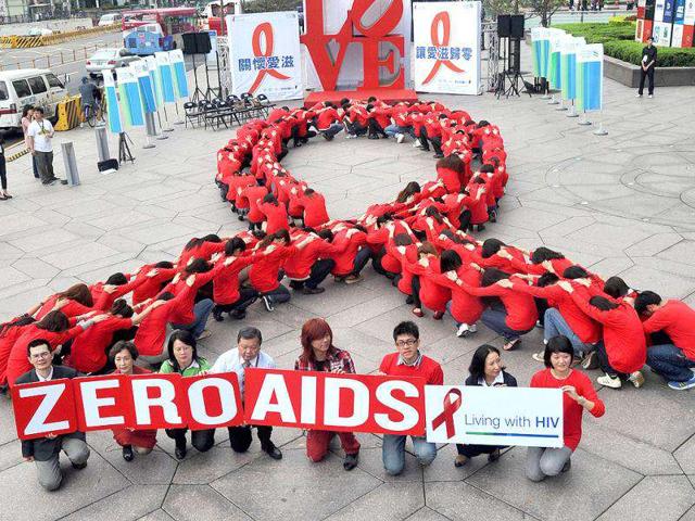 Dozens of volunteers join a human chain in the form of a red ribbon, a symbol of "love and care" for HIV and AIDS carriers worldwide, at a gathering in downtown Taipei ahead of World AIDS Day. The theme of the 2011 global campaign to fight AIDS is 'Getting to Zero'.