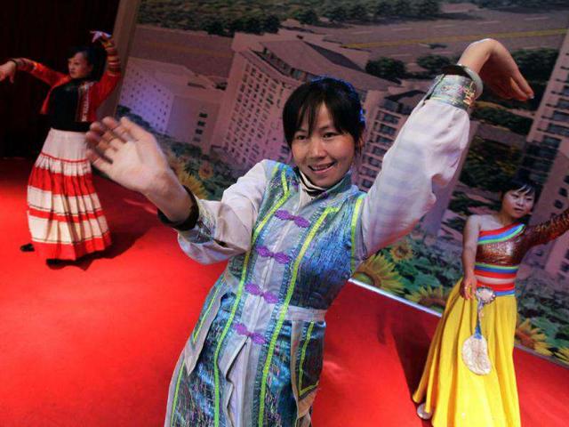 Drug addicts dance as they rehearse for a AIDS Day performance at Harmonious Home Rehabilitation Community, on the outskirts of Kunming, capital of southwest China's Yunnan province.
