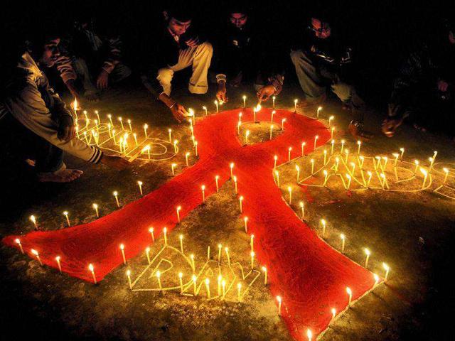 Students light candles for HIV and AIDS awareness in Agartala, Tripura.