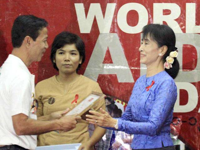 Opposition leader and Nobel peace laureate Aung San Suu Kyi meets musicians during an event to mark World AIDS Day celebration at her National League for Democracy (NLD) party's headquarters, in Yangon, Myanmar. (AP Photo/Khin Maung Win)