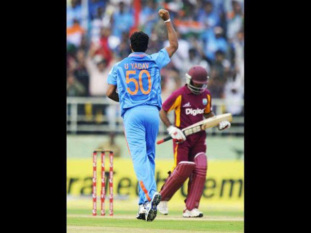 Umesh Yadav celebrates after taking the wicket of West Indies cricketer Adrian Barath during their second ODI match at The YS Rajasekhara Reddy Cricket Stadium in Visakhapatnam.