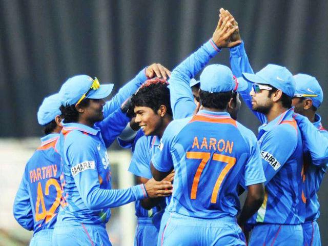 Teammates congratulate Umesh Yadav (C) for taking the wicket of Marlon Samuels of WI during their second ODI match at The YS Rajasekhara Reddy Cricket Stadium in Visakhapatnam.