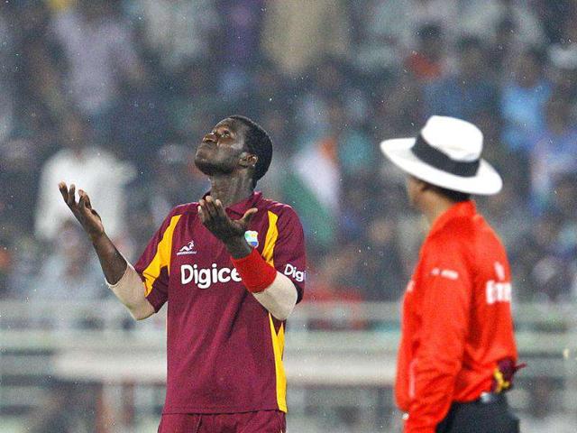 West Indies' captain Darren Sammy, left, gestures to the umpire after rain stopped play during their second one day international cricket match against India in Visakhapatnam. (AP Photo)