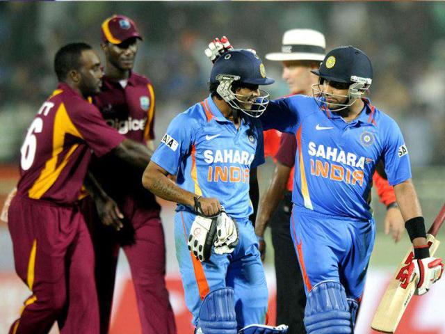 Indian cricketer Rohit Sharma (R) and Ravidra Jadeja exit the ground after winning the second One Day International (ODI) match between Indian and West Indies at The YS Rajasekhara Reddy cricket Stadium in Visakhapatnam. (AFP Photo)