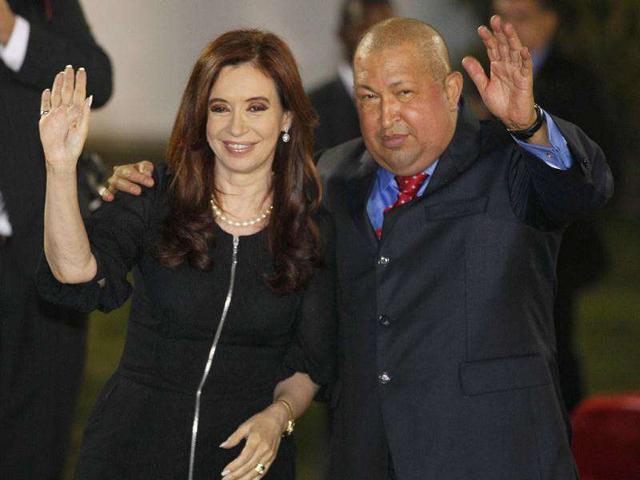 Argentina's President Cristina Fernandez, left, and Venezuela's President Hugo Chavez wave after the group photo of the Community of Latin American and Caribbean States, CELAC, summit in Caracas, Venezuela. AP Photo/Ricardo Mazalan