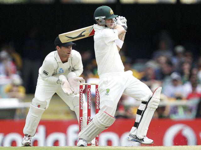 Australia's Michael Clarke (R) plays a shot against New Zealand as keeper Reece Young looks on during their first test cricket match at the Gabba in Brisbane. Reuters/Jason O’Brien