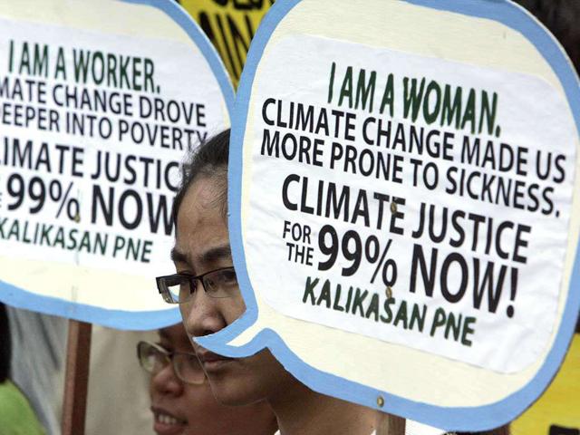 Protesters display their placards during a rally in observance of World Climate Day near the US Embassy Saturday, in Manila, Philippines.