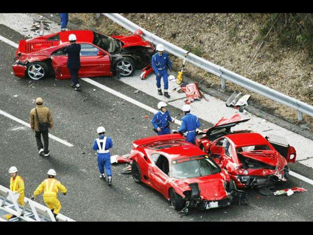 Police officers investigate wrecked luxury cars at the site of a traffic accident on the Chugoku Expressway in Shimonoseki, southwestern Japan. Reuters/Kyodo
