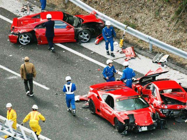 Police officers investigate wrecked luxury cars at the site of a traffic accident on the Chugoku Expressway in Shimonoseki, southwestern Japan in May 2011. Reuters photo