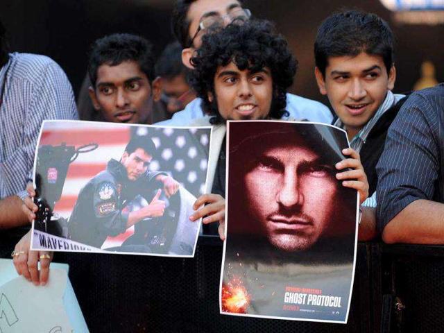 Indian fans waiting eagerly for the stars with posters in their hands. AFP PHOTO/Indranil Mukherjee