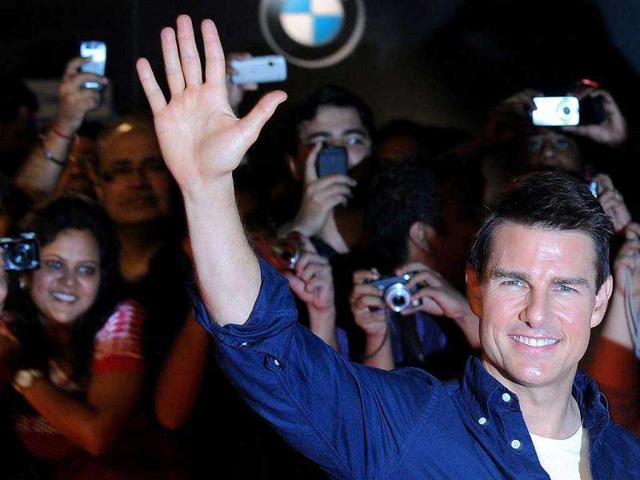 Hollywood hottie waves to the public with a big smile. AFP PHOTO/Indranil Mukherjee