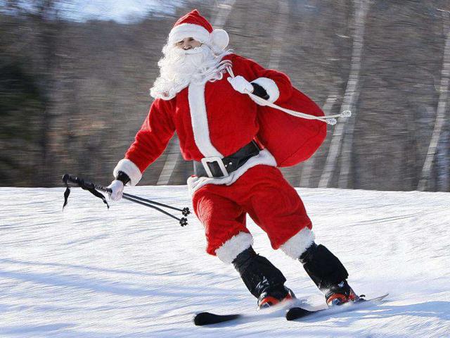 One of the 250 Santas participating in a fundraising event takes a run at Sunday River Ski Resort in Newry, Maine. To qualify for a free lift ticket each Santa had to wear a full red Santa costume, complete with beard, and donate at least $10 to the Bethel Rotary Club's annual drive to provide gifts for the area's needy children.