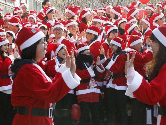 About 200 voluntary workers, dressed in Santa Claus outfits, perform as they launch an event to visit and give Christmas gifts to prematurely born babies in Seoul.