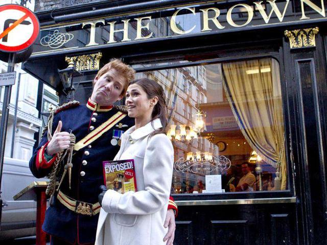 Lookalikes of Prince Harry and Pippa Middleton, stop outside the Crown Pub during a 'Royal walkabout' in central London, to launch the new book, Exposed, by a British artist and photographer Alison Jackson. AP Photo
