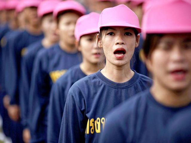 Female prisoners sing the national anthem as they are released from Bang Kwang Central Prison in Bangkok.Over 2,700 prisoners were released from prison after being given royal pardons on the 84th birthday of Thailand's King Bhumibol Adulyadej.
