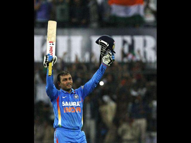 Virender Sehwag celebrates after scoring 200 runs during their fourth one-day international cricket match against West Indies in Indore. Reuters Photo