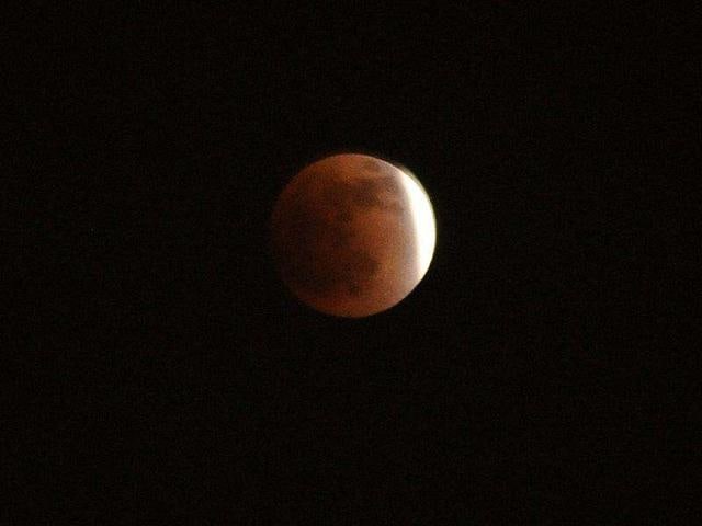 The moon is pictured reaching its peak during a full lunar eclipse in Kabul. (AFP Photo)