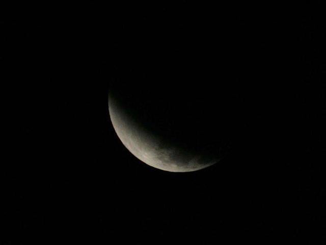 The lunar eclipse sets over the North Shore of Oahu in Haleiwa, Hawaii. (Reuters)